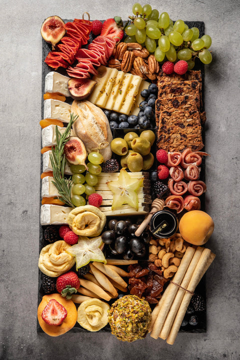 Stone tray with cheeses and cold meats