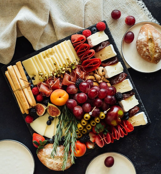 Stone tray with cheeses and cold meats